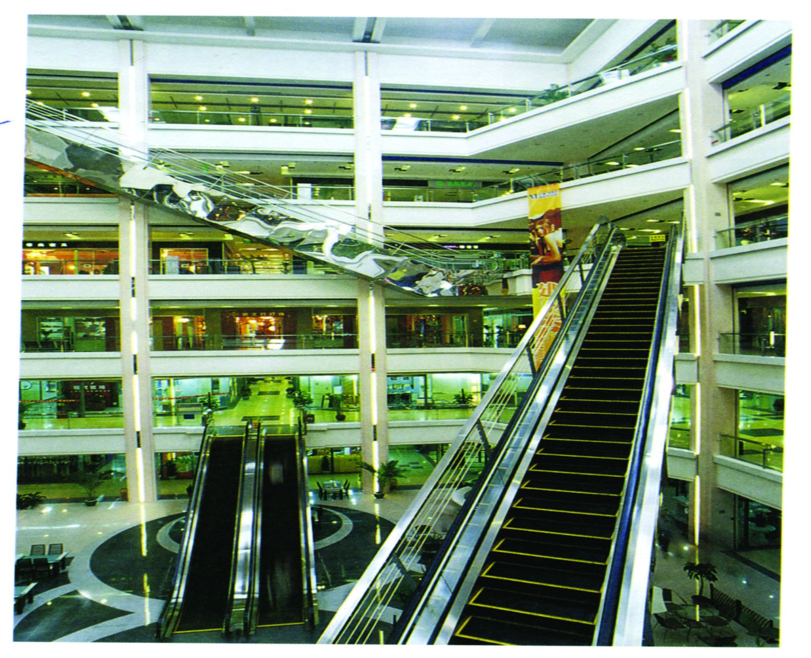 Escalator rising through a mall atrium